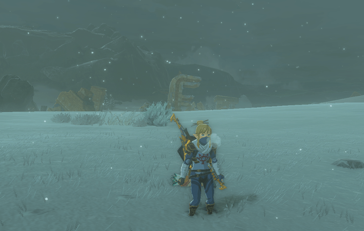 Link, dressed up in a Shiekah uniform, freezes and shivers outside in the Hebra snowy plains in Tears of the Kingdom