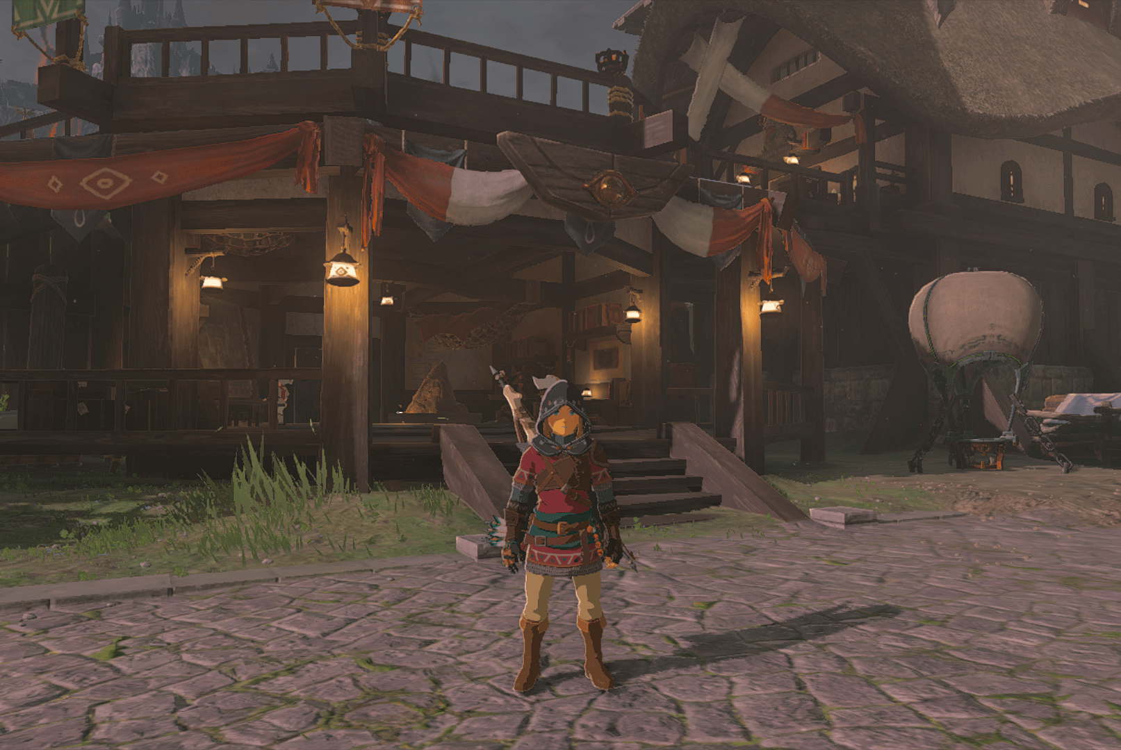 Link wearing the Hylian Armor set in The Legend of Zelda: Tears of the Kingdom. The set layers a tunic that has red and green accents, and leather belts. He wears basic beige pants with it. He looks cute!