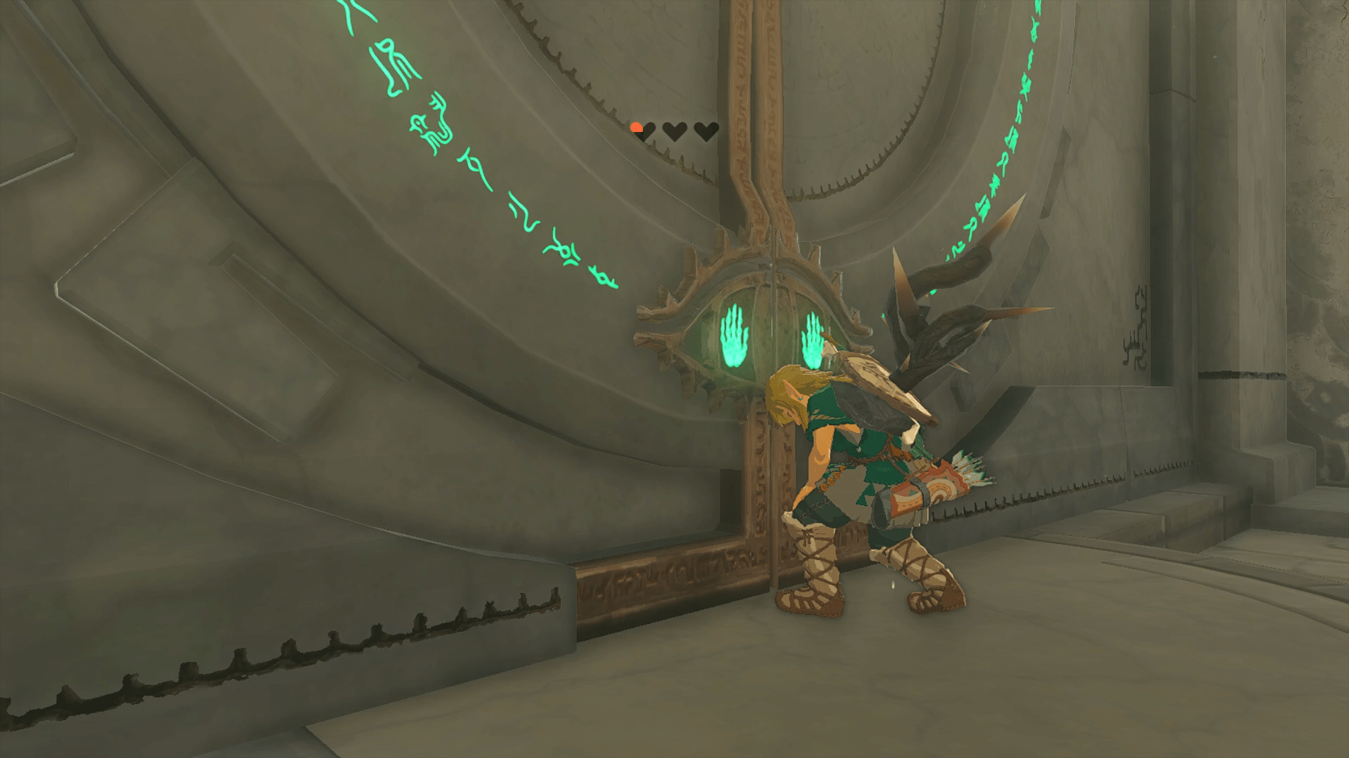 Link standing hunched over in front of a large door with a low health pool in The Legend of Zelda: Tears of the Kingdom