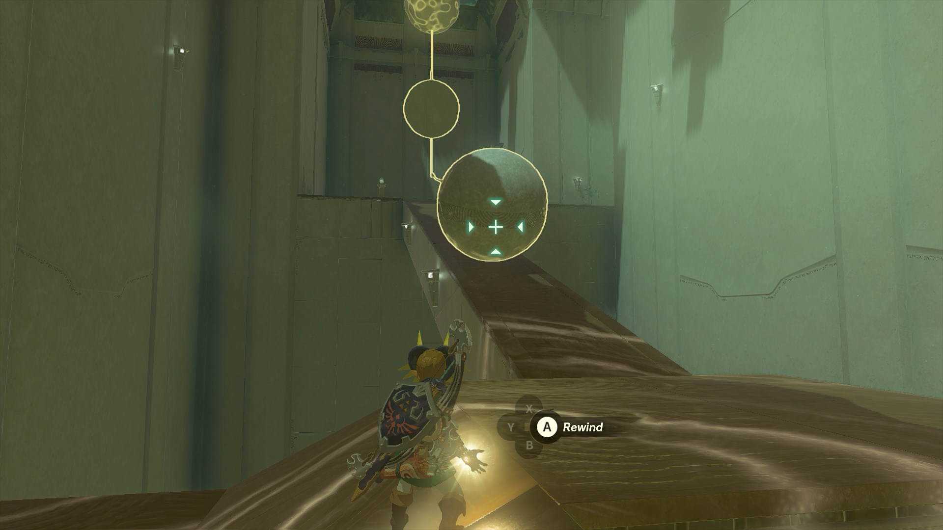 Link using the Recall ability on a stone ball rolling down a ramp in the Tauyosipun Shrine in The Legend of Zelda: Tears of the Kingdom.