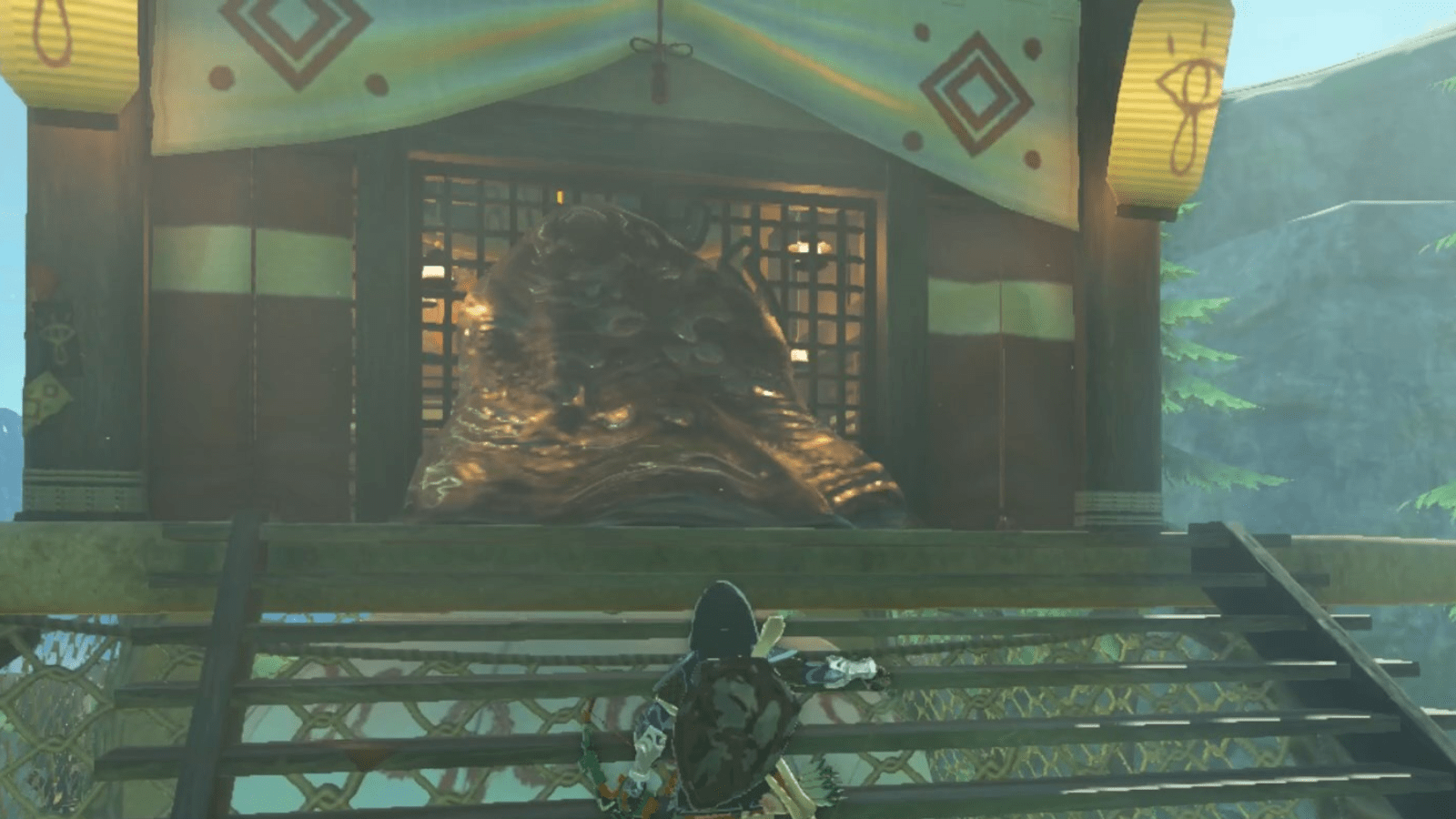 Link stands at the base of the stairs, looking up at sludge blocking the door of the Upland Zorana Skyview Tower in The Legend of Zelda: Tears of the Kingdom