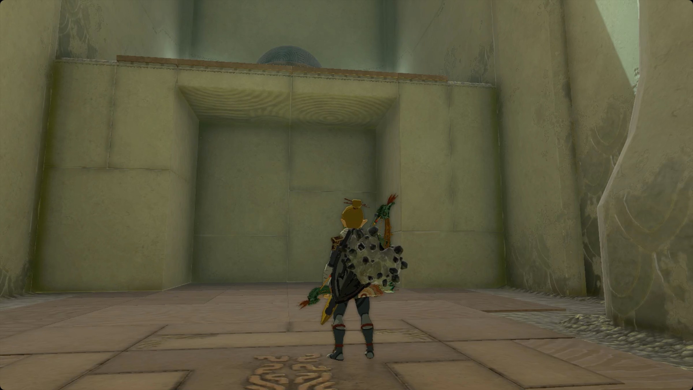 The Legend of Zelda: Tears of the Kingdom Link standing near a platform to use Ascend through to reach a large metal ball in Mayamats Shrine