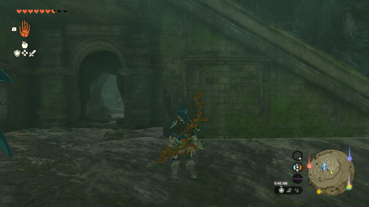 Link stands next to a hole underneath a staircase that leads to the chest room in Zelda: Tears of the Kingdom