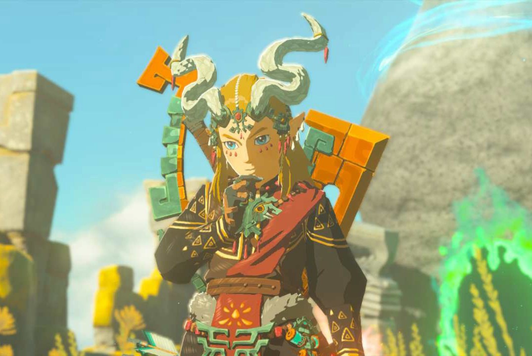 Link stands with a thinking pose wearing the full Ember Armor set in Zelda: Tears of the Kingdom. The headwear gives him curvy horns and long hair.