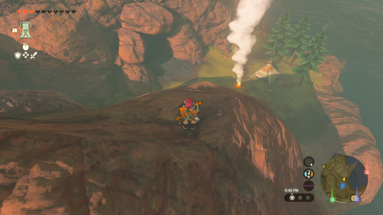 Link overlooks the Cephla Lake Cave entrance from above, standing on a cliff in Zelda: Tears of the Kingdom