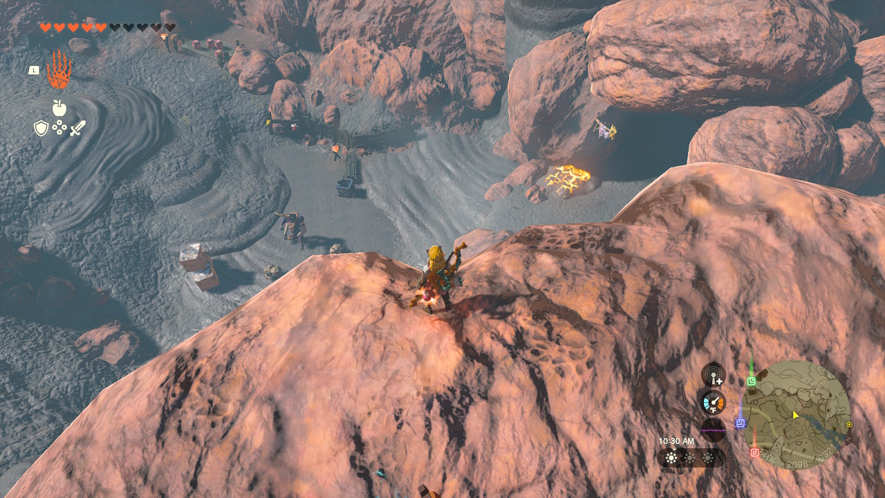 Link overlooks the entrance to the Goronbi River Cave from a cliff above in Zelda: Tears of the Kingdom