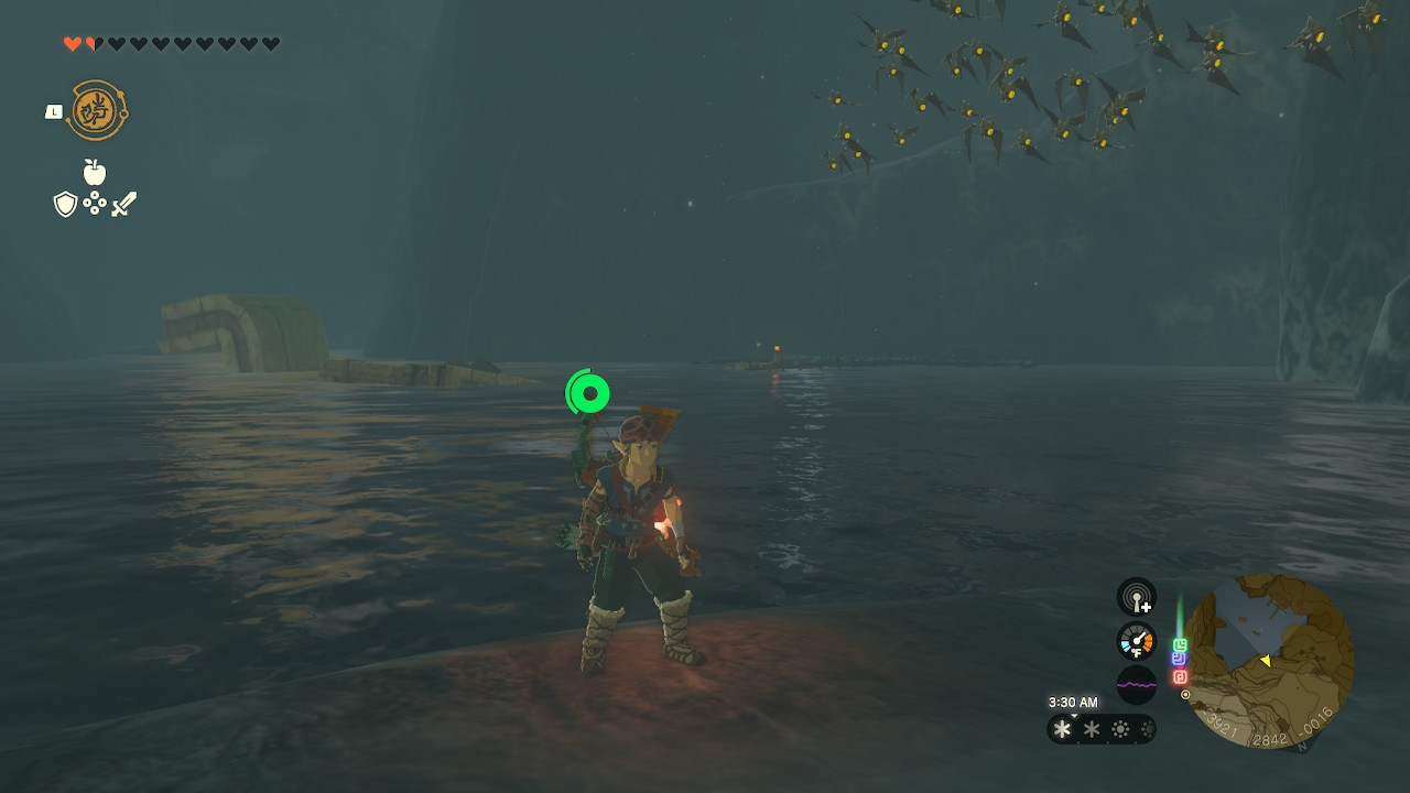 Link stands in front of the Lake Kilsie Cave, looking backwards, in Zelda: Tears of the Kingdom
