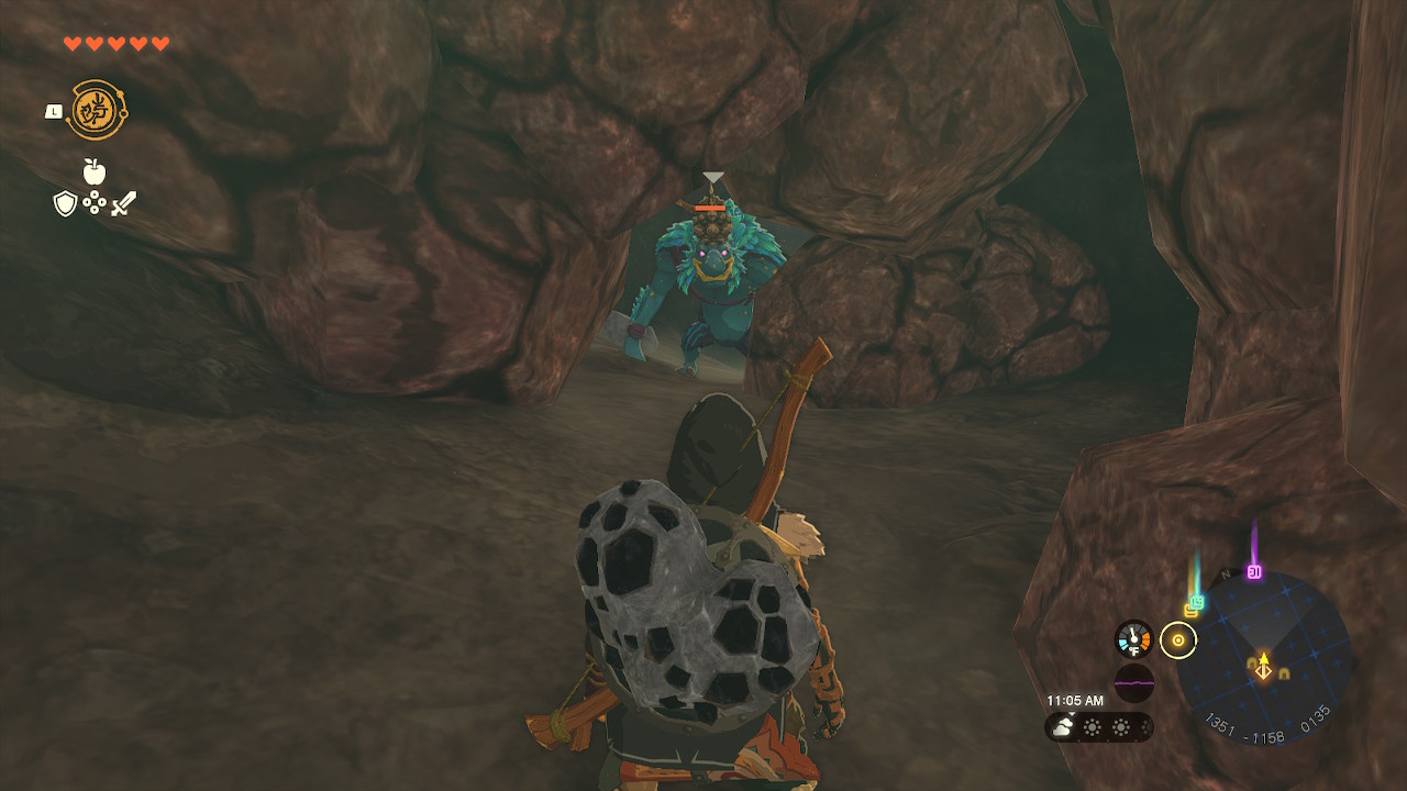 A Blue Horriblin takes a peak at Link from a gap in a rock wall in Zelda: Tears of the Kingdom