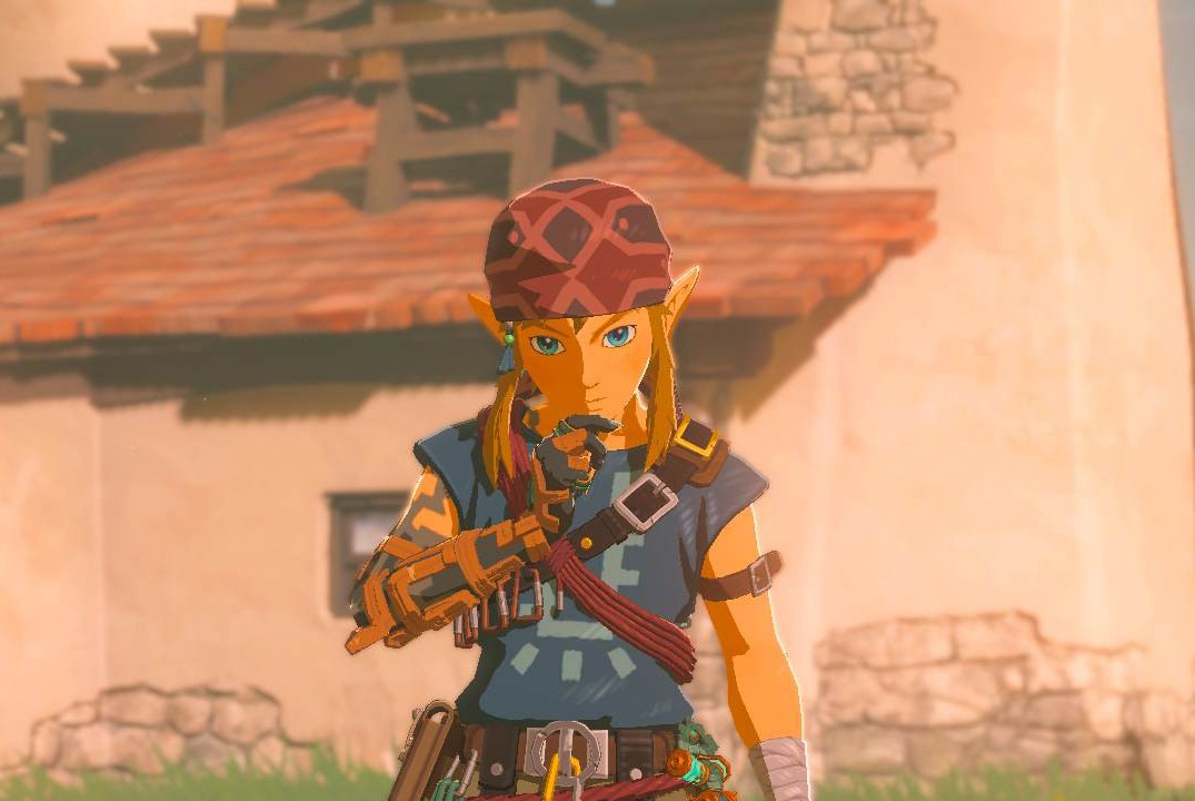 Link stands lost in thought in front of the camera while wearing the Climbing Armor set in Zelda: Tears of the Kingdom