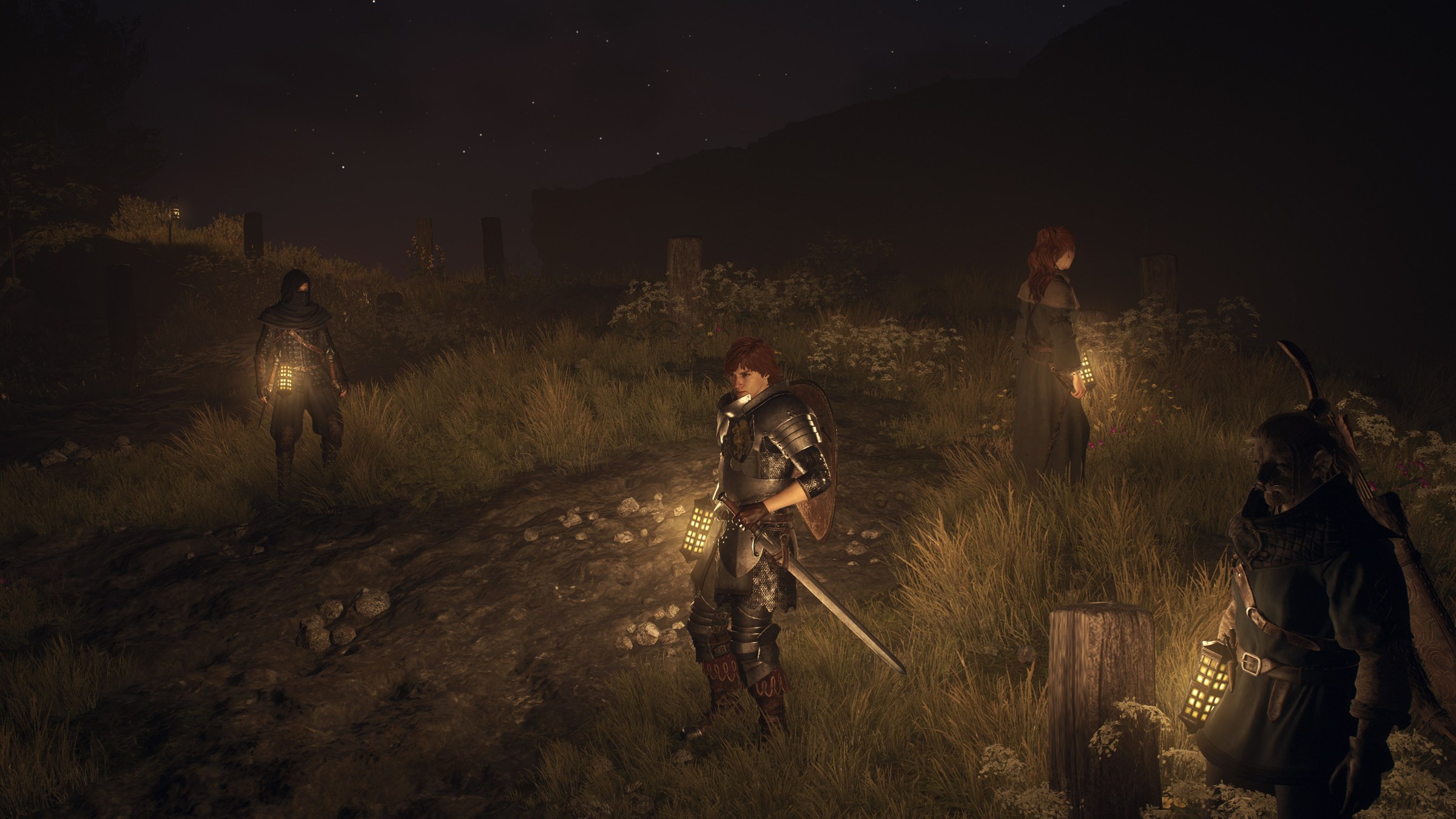 Dragon’s Dogma 2 adventuring party standing around at night time with their lanterns