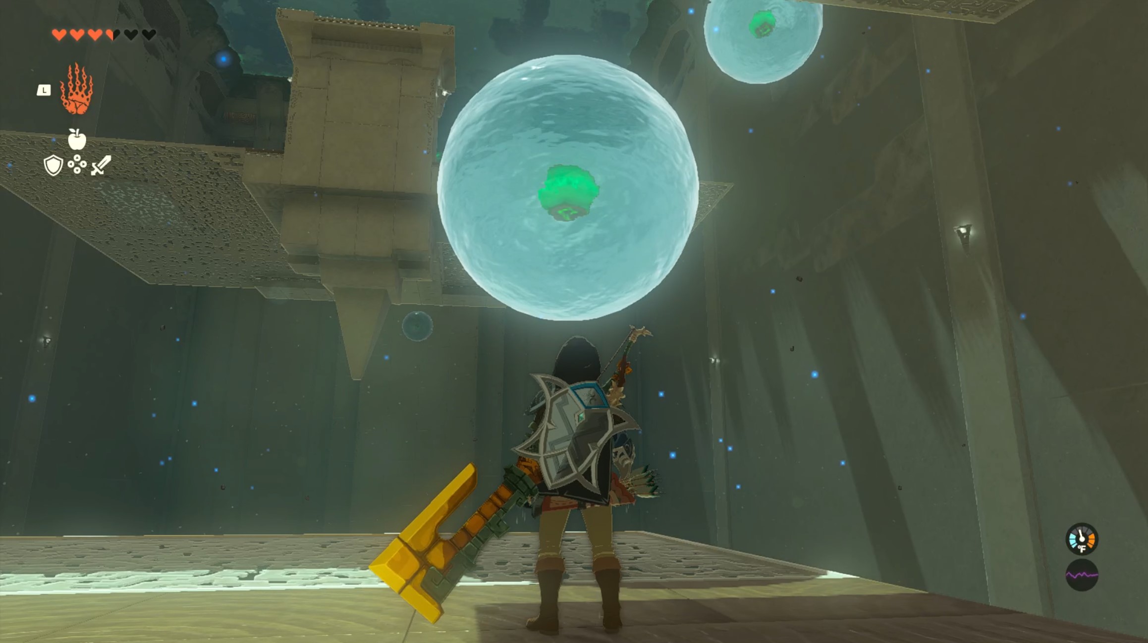 Link stands below a 8-foot-tall orb of water floating in the air. The inside of the water orb is a green eyeball creature.