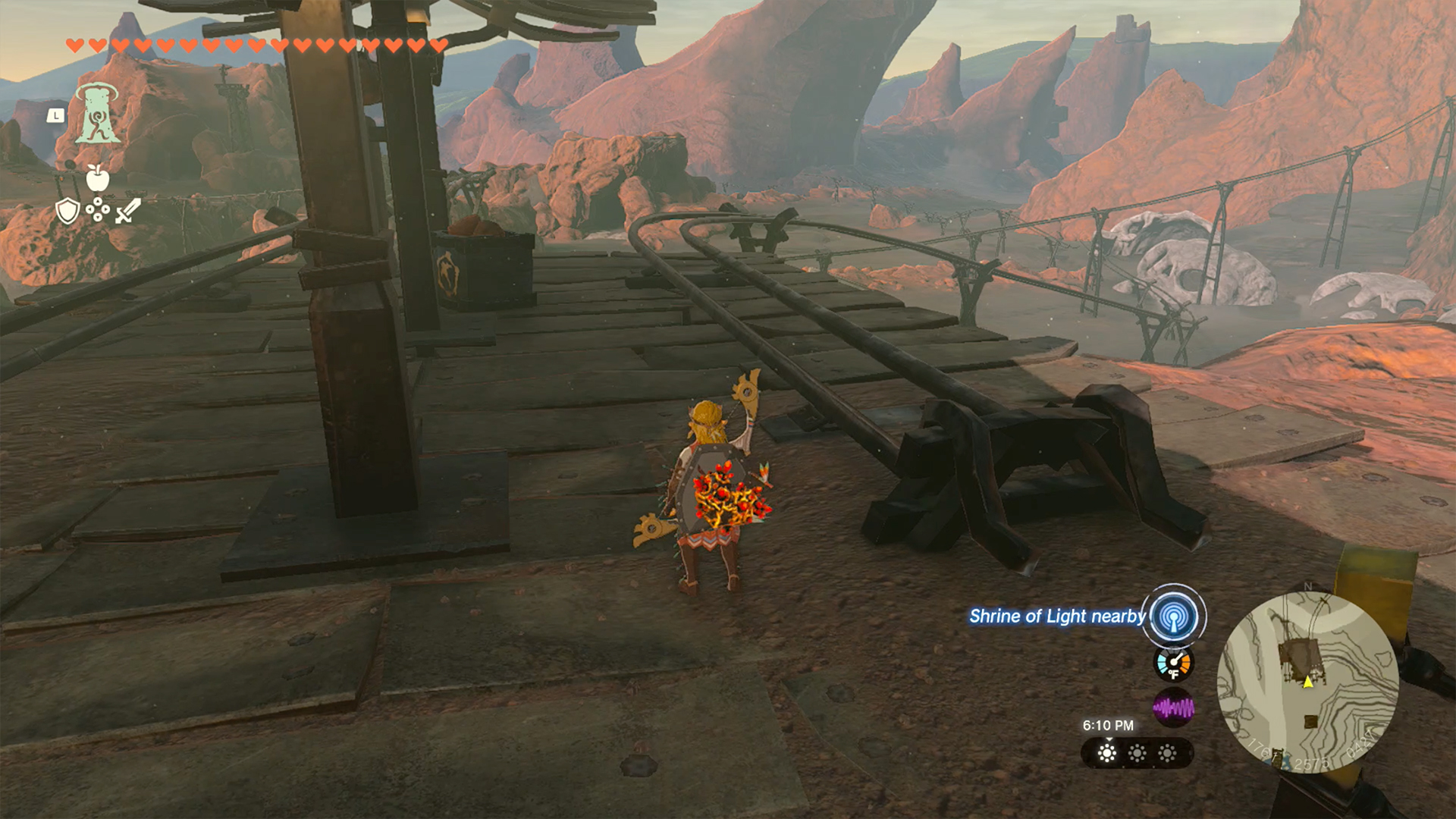 Link stands between two elevated railways in the Eldin Canyon region of Hyrule in The Legend of Zelda: Tears of the Kingdom