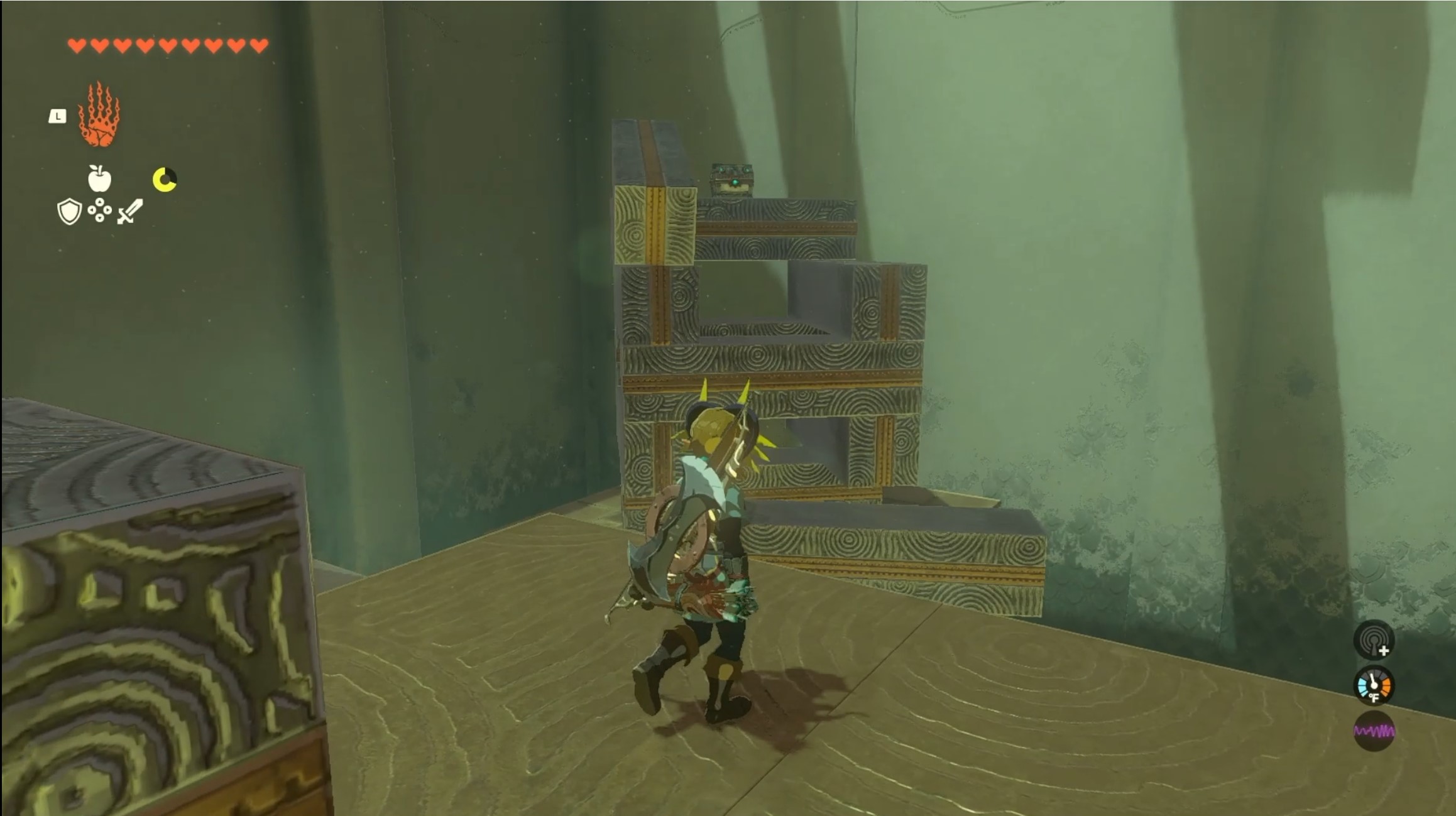 Link looks a stack of blocks, half demolished, with a treasure chest on top in the Jochi-iu Shrine in Zelda: Tears of the Kingdom.