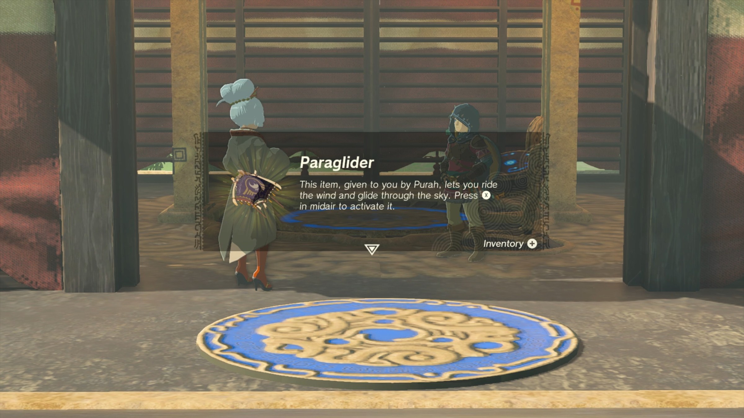 Purah, the Head of Lookout Landing, gives Link the paraglider at the bottom of the Lookout Landing Skyview Tower, in The Legend of Zelda: Tears of the Kingdom