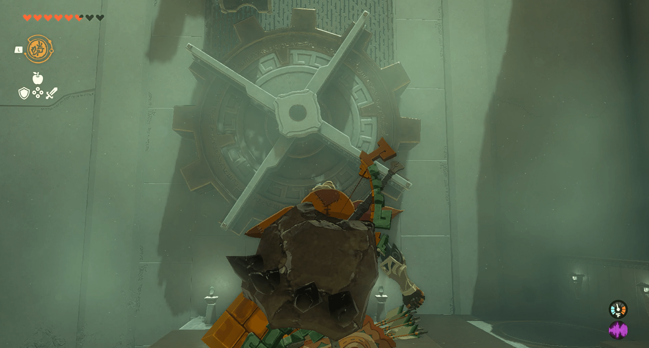 Link looking at a massive gear on a wall in the Sikukuu Shrine in Zelda: Tears of the Kingdom