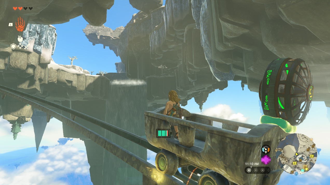 Link rides a mining cart with a fan on the Great Sky Island in Zelda Tears of the Kingdom.