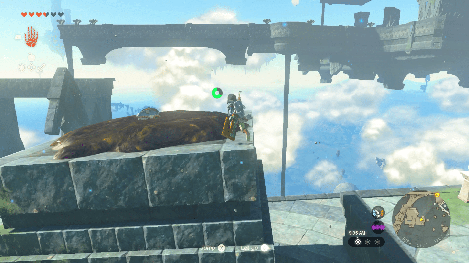 Link stands on a tall stone platform with the open sky behind it. The top of the platform is covered in brown sludge, which Link must remove to find a chest.