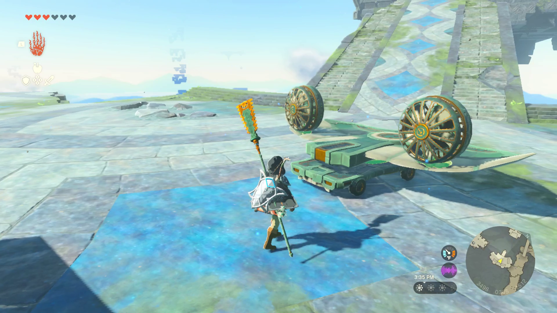 Link stands before a flat bird made out of stone. The bird has wheels mounted to its base, and a cylindrical fan on each wing. Activating the bird will move it up the ramp directly in front of it.