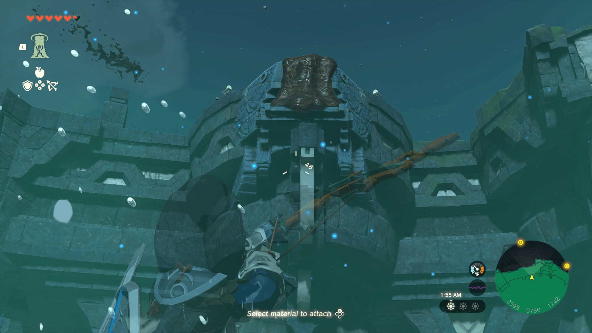 Link stands before a large stone pillar in the middle of a stone courtyard. At the top of the pillar, mud blocks a waterway a waterfall should be coming from.