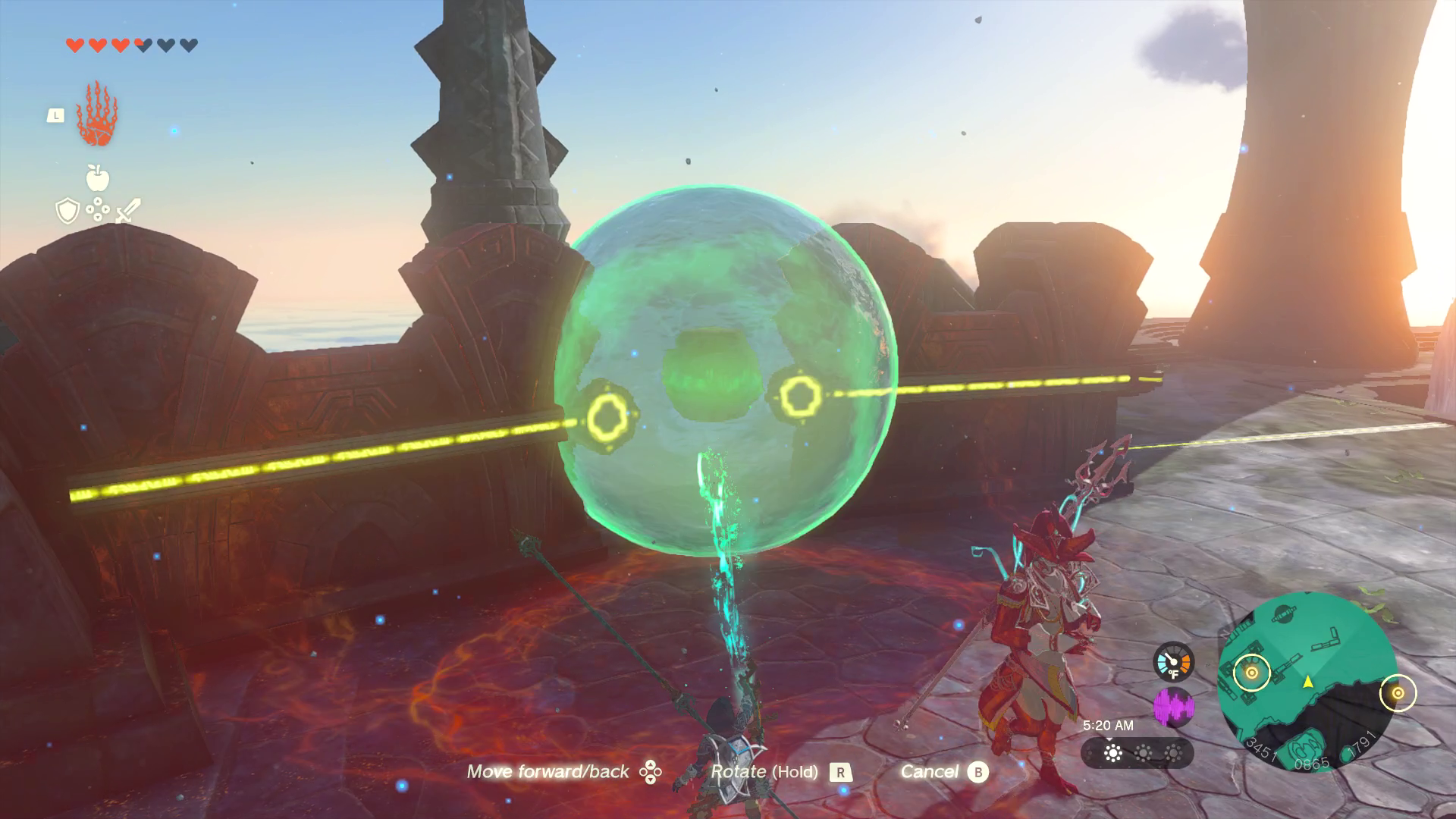 A large sphere of water floats above a red circle, and it glows green from the light of Link’s Ultrahand ability. Electrical cables just in from its left and right side.