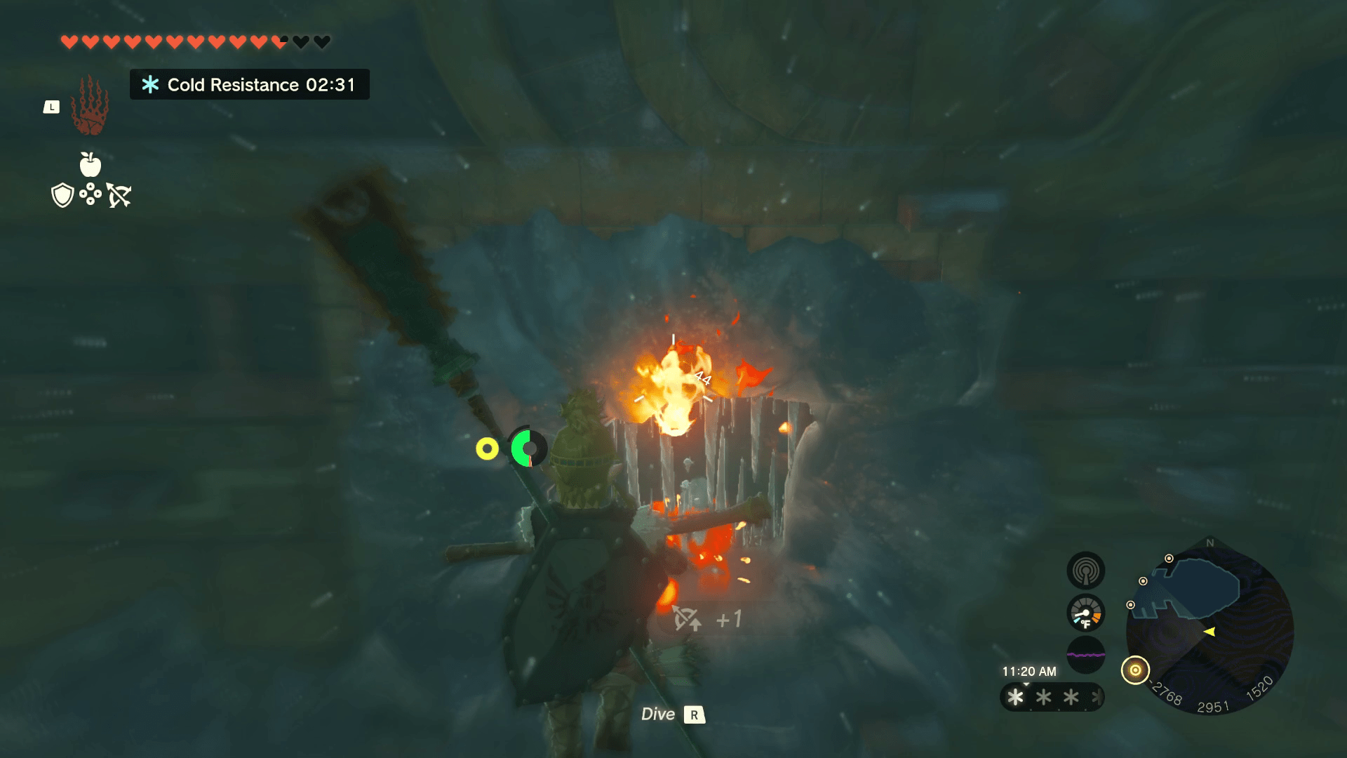 Link stands in front of a door blocked by icicles. A red goo is on the ground, and it’s leeching up flames to melt the ice.