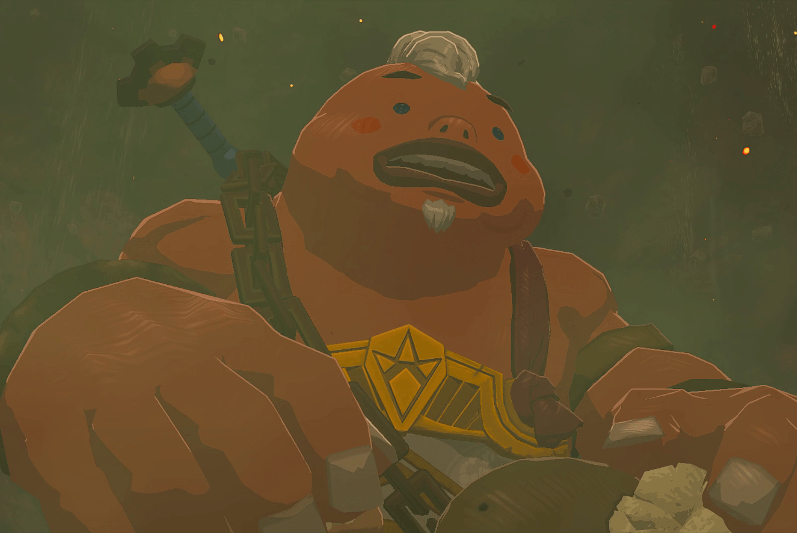 Yunobo, a Goron with a white tuft of hair and goatee, stands in shock as a cave crumbles around him in Tears of the Kingdom