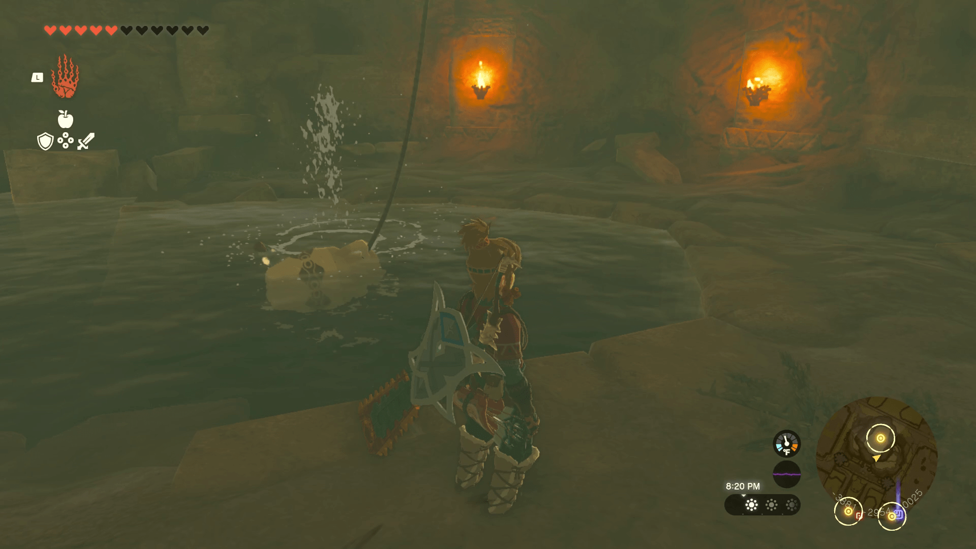 Link stands next to the water source of a well in Tears of the Kingdom. The well is lit up and has a vase and rope used to scoop water out hanging from the top