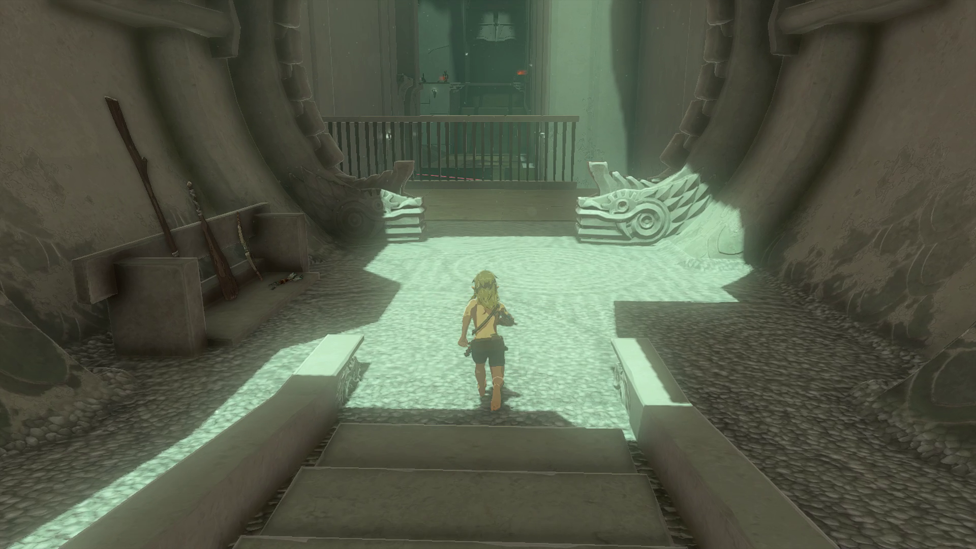 Link heads down the stairs in Miryotanog Shrine towards a small chamber with three weapons leaning against the left-hand wall