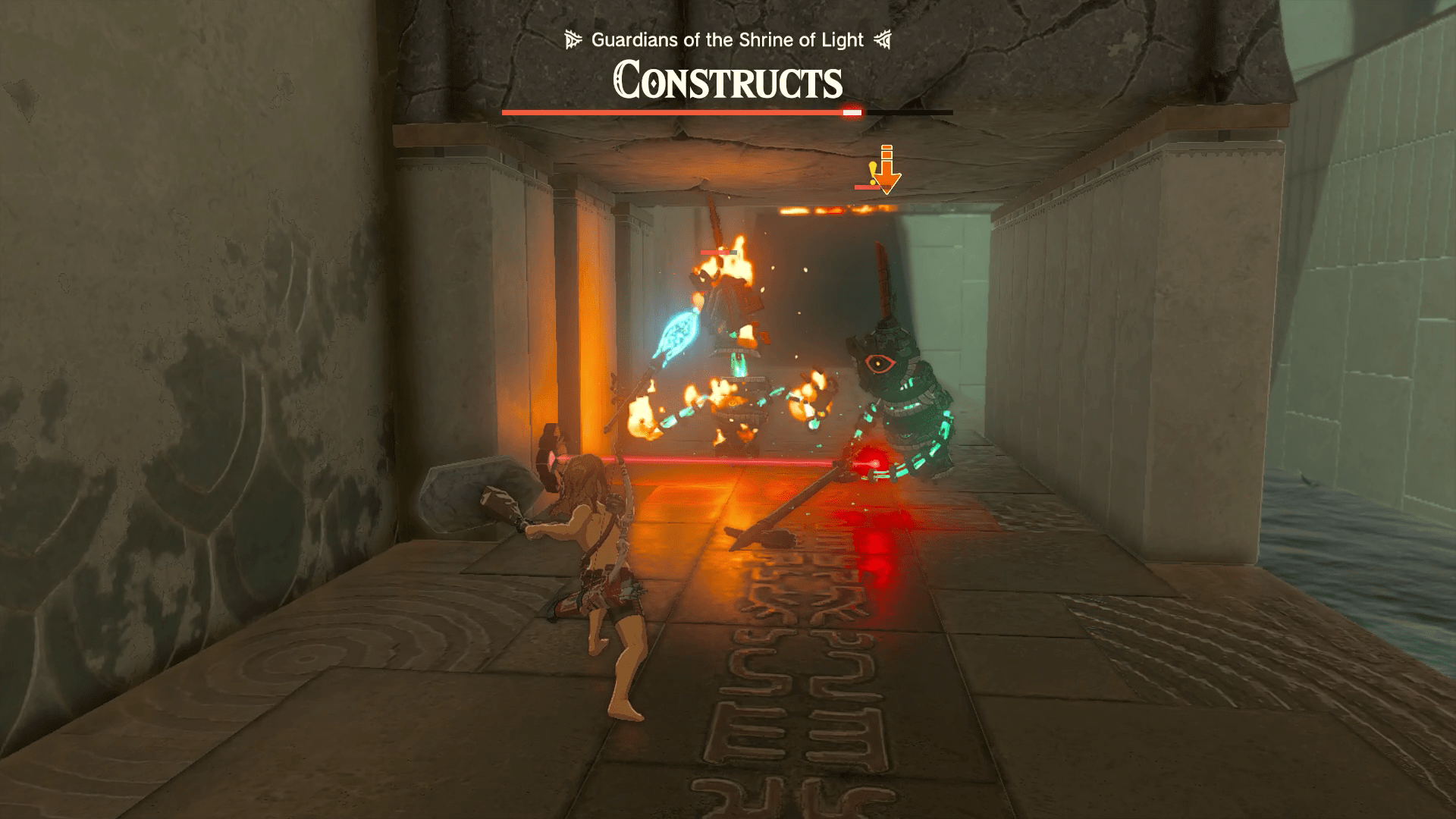 Two Constructs on their way to attack Link get burned up by a Flame Emitter Zonai device hidden behind a laser beam under a stone archway in Zelda: Tears of the Kingdom’s Miryotanog Shrine