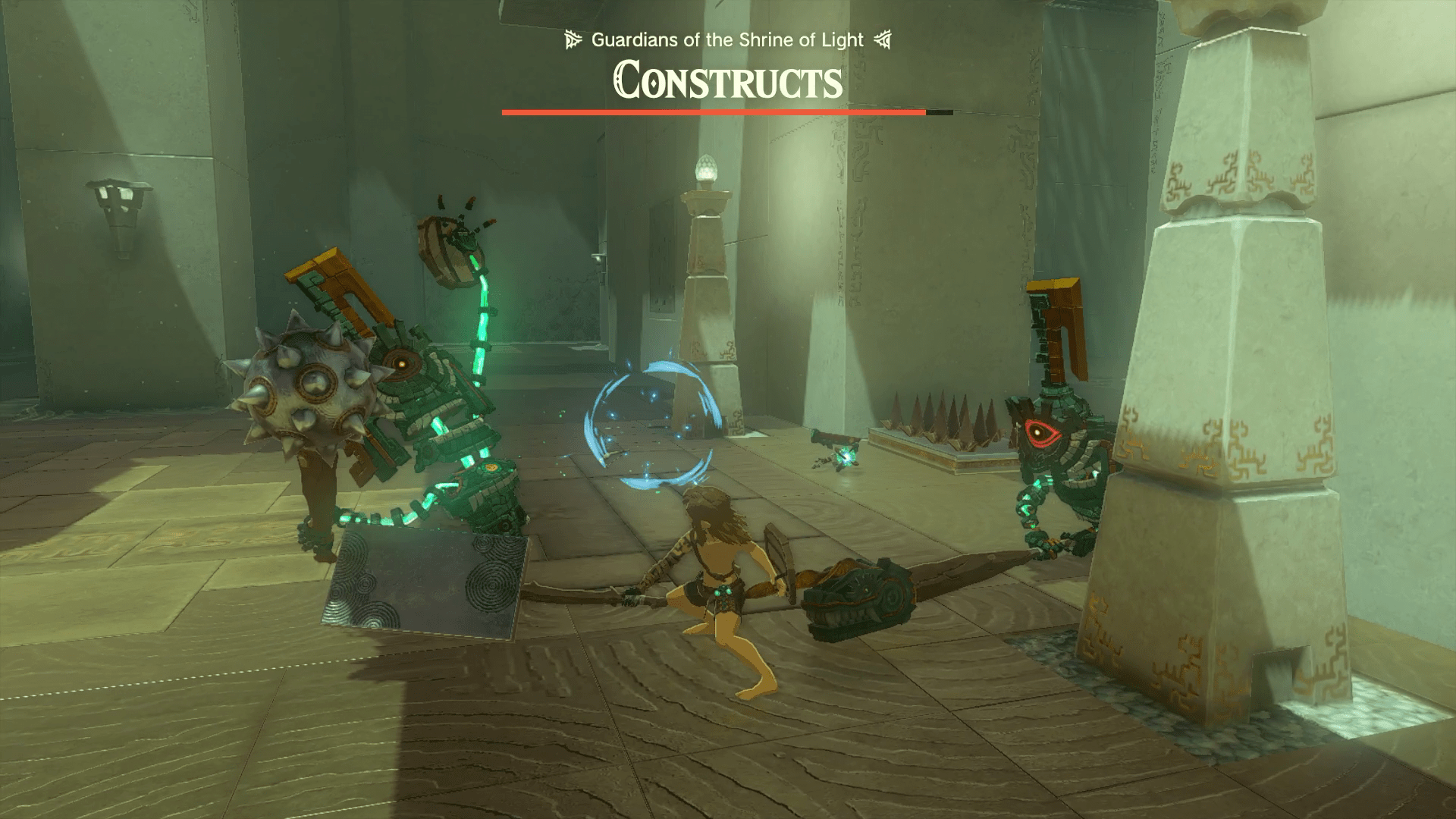 A mostly-naked Link fights several constructs in a shrine using some metal spikes attached to a stick in Tears of the Kingdom.