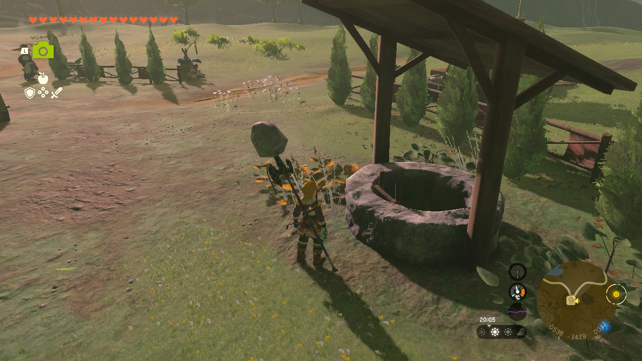 Link stands next to a well by the Highland Stable in Zelda Tears of the Kingdom.