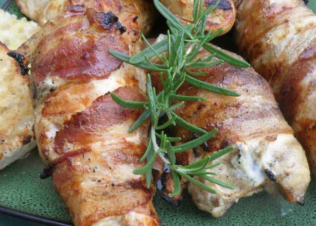 Savor the exquisite flavors of grilled chicken infused with rosemary and topped with crispy bacon.